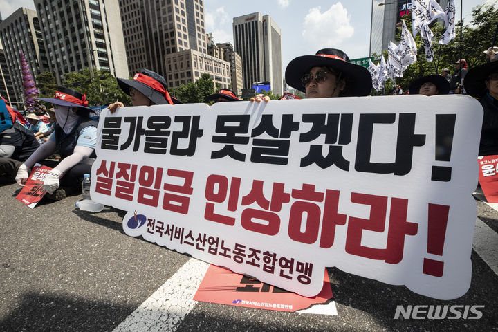 [서울=뉴시스] 김근수 기자 = 전국서비스산업연맹노동조합과 전국민주노동조합 총연맹 조합원들이 3일 서울 중구 세종대로에서 열린 민주노총 총파업 대회에서 피켓 시위를 하고 있다. 2023.07.03. ks@newsis.com