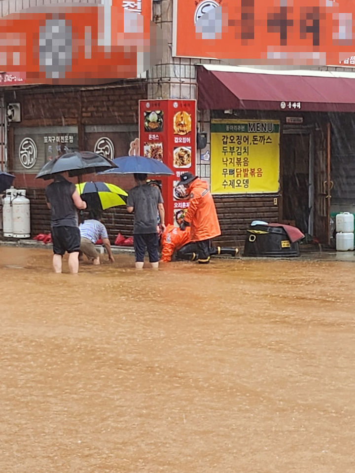 [군산=뉴시스] 김얼 기자 = 전북 대부분 지역에 호우경보가 발효된 14일 전북 군산시 구암현대아파드 일원에서 소방관들이 배수로 정리작업을 하고 있다. (사진=전북소방본부 제공) 2023.07.14. pmkeul@nwsis.com *재판매 및 DB 금지