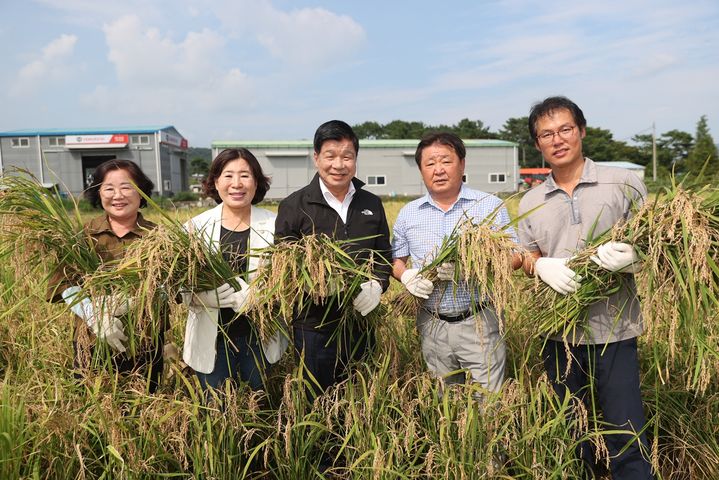 [고성(경남)=뉴시스] 신정철 기자= 경남 고성군은 지난 14일 고성읍 우산리 김형성 농가에서 올해 첫 벼 수확을 했다. 이날 풍년을 기원하는 첫 벼 수확 현장에는 이상근 고성군수(가운데), 최을석 고성군의회 의장, 허동원 도의원, 김향숙 고성군의회 부의장, 허옥희 군의원과 김진규 고성군 쌀전업농연합회장(오른쪽) 및 회원 30여 명이 참석해 첫 수확을 축하했다.(사진=고성군 제공).2023.08.15. photo@newsis.com *재판매 및 DB 금지