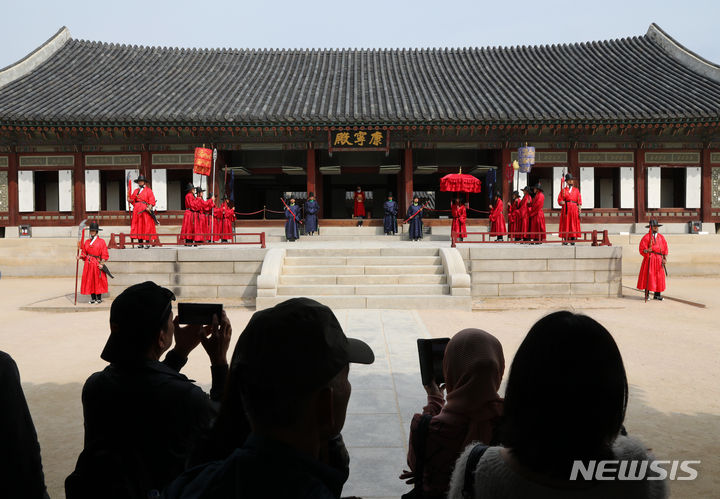 [서울=뉴시스] 배훈식 기자 = 13일 오전 서울 종로구 경복궁을 찾은 관광객들이 궁궐의 일상 모습을 체험할 수 있는 '왕가의 산책' 재연 행사를 관람하고 있다. 2023.10.13. dahora83@newsis.com