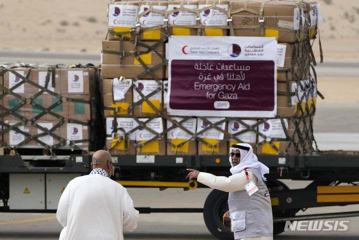 [알아리시=AP/뉴시스]지난 11월19일(현지시각) 이집트 알 아리시 공항에서 카타르 적신월사(적십자) 관계자들이 가자지구로 보낼 구호 물품을 수송하고 있다. 2023.12.02.