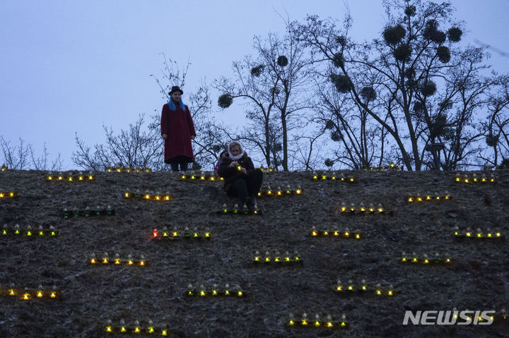 [키이우=AP/뉴시스] 11월25일(현지시각) 우크라이나 키이우 시민들이 1932~33년 대기근(홀로도모르) 희생자들을 기리는 기념비 언덕에 촛불을 밝히고 있다. 홀로도모르는 1932~33년 이시오프 스탈린 치하 소련 시대에 자행된 대기근으로 기록이 부실해 집계에 편차가 있지만 대체로 250만~300만 명 정도가 숨진 것으로 추산된다. 2023.11.26.