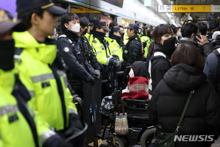 [서울=뉴시스] 김선웅 기자 = 전국장애인차별철폐연대 회원들이 22일 서울 지하철 4호선 혜화역에서 장애인 이동권 보장을 촉구하고 있다. 2024.01.22. mangusta@newsis.com