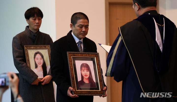 [서울=뉴시스] 김선웅 기자 = 15일 서울 구로구 성공회대학교에서 열린 학위수여식에서 이태원 참사로 유명을 달리한 故 유연주·진세은 학생의 유족이 명예학사학위를 받고 있다. 2024.02.15. mangusta@newsis.com