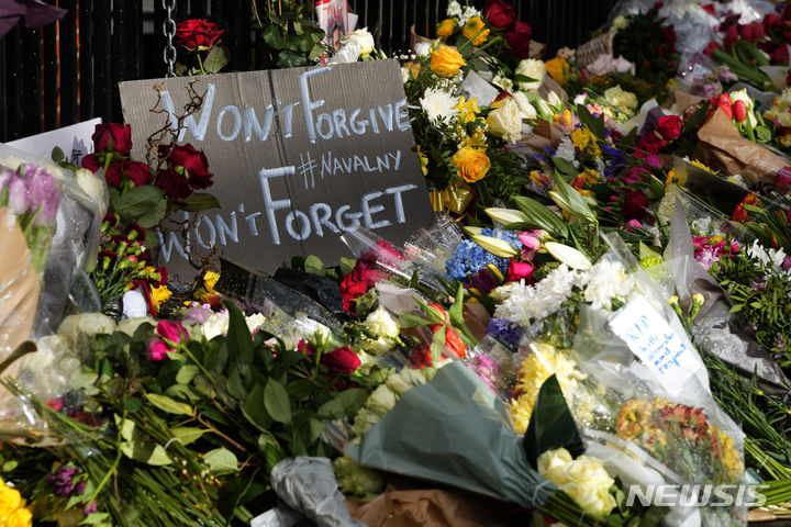 [런던=AP/뉴시스] 18일(현지시각) 영국 런던에 있는 러시아 대사관 앞에 러시아 야권 지도자 알렉세이 나발니(47)의 죽음을 애도하는 꽃들과 손팻말이 놓여 있다. 나발니는 지난 16일 수감 중이던 러시아 최북단 시베리아 야말로네네츠 자치구 제3교도소에서 갑작스레 사망해 러시아인들에게 충격을 줬다. 그의 시신에서는 멍 자국과 심폐소생술(CPR)의 흔적이 발견된 것으로 알려졌다. 2024.02.19.