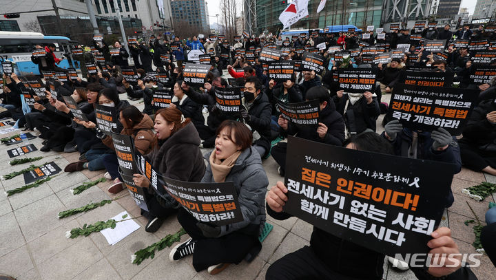 [서울=뉴시스] 홍효식 기자 = 24일 오후 서울 종로구 보신각 앞에서 열린 전세사기 피해자 1주기 추모문화제에서 참석자들이 전세사기 특별법 개정안 통과 및 재발방지 대책을 촉구하며 피켓을 들고 구호를 외치고 있다. 2024.02.24. yesphoto@newsis.com