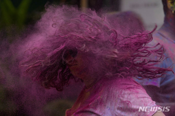 [뭄바이=AP/뉴시스] 25일(현지시각) 인도 뭄바이에서 열린 홀리 축제에 참가한 한 소녀가 색 가루를 털어내고 있다. 2024.03.26.