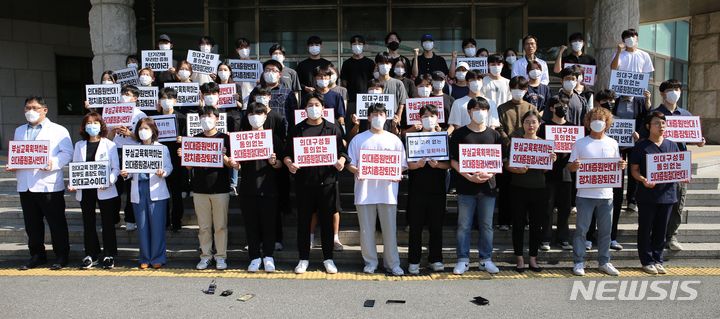 [청주=뉴시스] 서주영 기자 = 충북대의대 교수와 학생들이 21일 충북대학교 대학본부 앞에서 의대 증원 반대를 촉구하는 피켓 시위를 하고 있다. 2024.05.21. juyeong@newsis.com