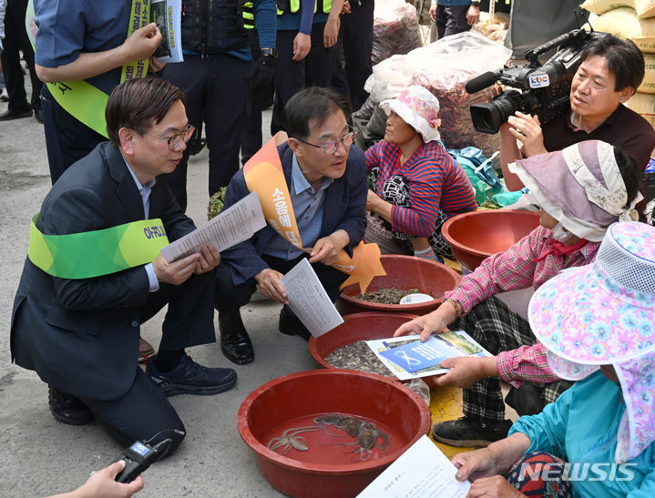 [무안=뉴시스] 박기웅 기자 = 24일 전남 무안군 무안전통시장에서 열린 '민·군 통합공항 무안 이전 홍보캠페인'에서 고광완 광주시 행정부시장이 상인들에게 홍보물을 나눠주고 있다. 2024.05.24. pboxer@newsis.com