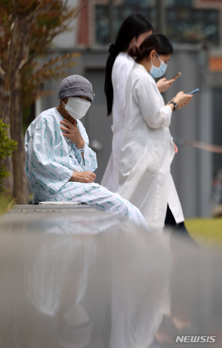 [서울=뉴시스] 김명년 기자 = 서울대학교 의과대학 교수들이 오는 17일부터 응급·중환자실을 제외하고 전체 휴진을 결정한 가운데 7일 오후 서울 종로구 서울대학교병원에서 한 환자가 야외의자에 앉아 있다. 2024.06.07. kmn@newsis.com