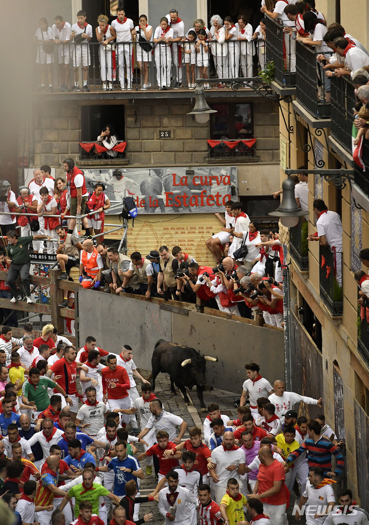 [팜플로나=AP/뉴시스] 11일(현지시각) 스페인 팜플로나에서 열리고 있는 연례 산 페르민 축제 중 황소와 달리기(엔시에로) 참가자들이 골목길을 달리고 있다. 2023.07.11.