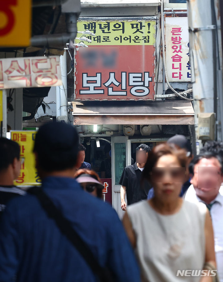 [서울=뉴시스] 김근수 기자 = 대한육견협회가 '개 식용 종식법'(개의 식용 목적의 사육·도살 및 유통 등 종식에 관한 특별법)의 시행을 앞둔 1일 "지원대책 없는 폐업 이행계획을 거부한다"고 밝혔다. 사진은 초복이었던 지난달 15일 오후 서울 시내의 한 보신탕 골목에서 시민들이 점심식사를 하기 위해 이동하는 모습. 2024.08.01. ks@newsis.com