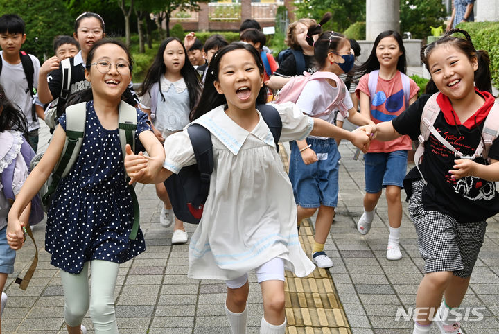 [수원=뉴시스] 김종택 기자 = 19일 경기도 수원시 영통구 신성초등학교에서 3학년2반 학생들이 여름 방학식을 마치고 밝게 웃으며 하교하고 있다. 2024.07.19. jtk@newsis.com