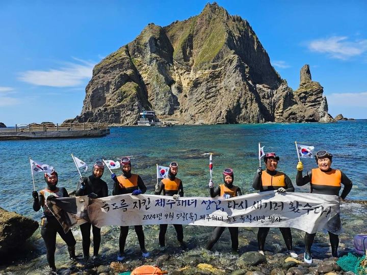 [제주=뉴시스] 지난 5일 독도를 찾은 제주해녀들이 '독도를 지킨 제주해녀 정신, 다시 새기러 왔수다'라고 쓰인 현수막을 들고 있다. (사진=오영훈 제주도지사 SNS 갈무리) 2024.09.06. photo@newsis.com *재판매 및 DB 금지