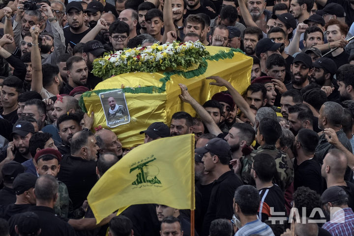 (Beirut=AP/Newsis) On the 18th (local time), Hezbollah fighters are carrying one of the coffins containing the bodies of four people killed by a pager explosion in the southern suburbs of Beirut, Lebanon. On the 17th, 12 people were killed and 2,800 were injured when thousands of pagers exploded simultaneously across Lebanon, and on the 18th, radios used by Hezbollah exploded in various parts of Lebanon, killing at least 3 and injuring 100. 2024.09.19.