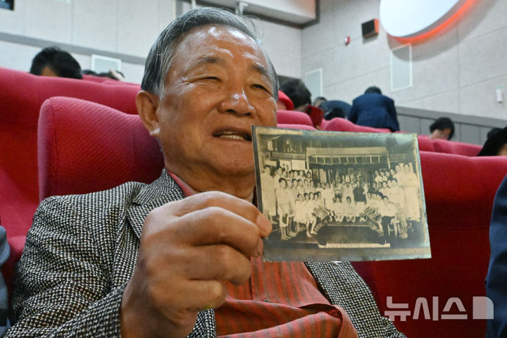 [광주=뉴시스] 이영주 기자 = 28일 오후 광주 동구 광주독립영화관에서 열린 일제강제동원 피해자 고발대회에 참여한 서태석(84)씨가 1941년 일제에 의해 태평양 남양군도로 끌려간 아버지가 촬영된 단체사진을 들어보이고 있다. 2024.09.28. leeyj2578@newsis.com