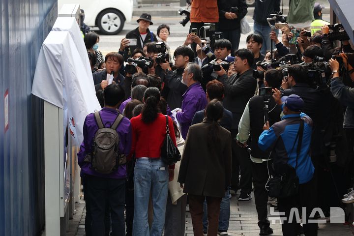 [서울=뉴시스] 추상철 기자 = 28일 오전 서울 용산구 이태원역 1번 출구 인근 사고 현장에서 열린 10.29 이태원 참사 2주기 '기억과 안전의 길' 빌보드 개막 기자회견에서 유가족들이 작품을 보고 있다. (공동취재) 2024.10.28. photo@newsis.com