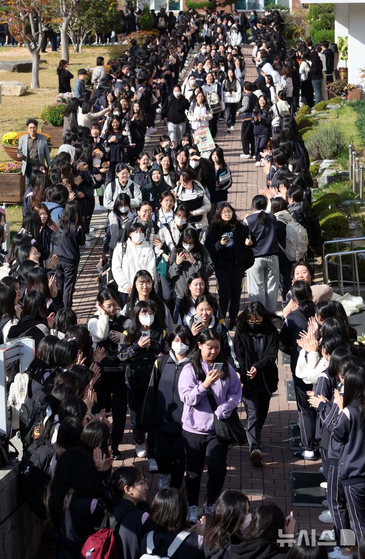 [부산=뉴시스] 하경민 기자 = 2025학년도 대학수학능력시험을 하루 앞둔 12일 부산 사상구 주례여고에서 고3 수험생들이 수험표를 받은 뒤 후배, 교사 등의 응원을 받으며 학교를 나서고 있다. 올해 부산지역에서는 수험생 2만7356명이 58개 시험장에서 수능에 응시한다. 2024.11.13. yulnetphoto@newsis.com