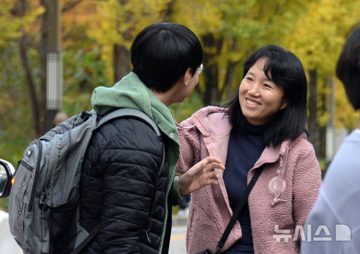 [전주=뉴시스] 김얼 기자 = 2025학년도 대학수학능력시험일인 14일 전북 전주시 전북대학교사범대학부설고등학교에서 한 학부모가 수험생인 아들에게 환한 미소를 보이며 응원하고 있다. 2024.11.14. pmkeul@newsis.com