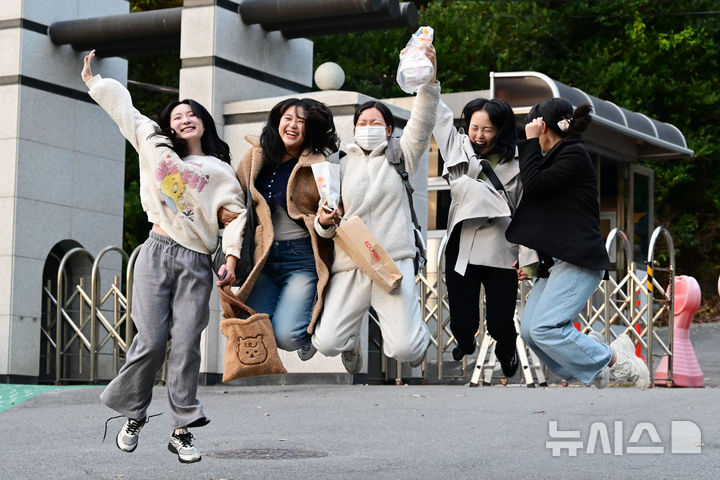 [광주=뉴시스] 이영주 기자 = 2025학년도 대학수학능력시험이 치러진 14일 오후 광주 남구 동아여고에서 시험을 마친 재수생과 격려하러 나온 친구들이 기뻐하며 점프하고 있다. 2024.11.14.leeyj2578@newsis.com