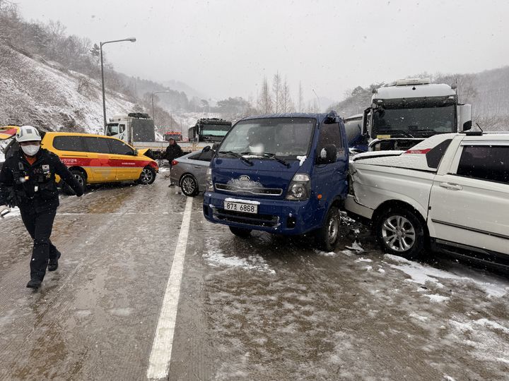 [보성=뉴시스] 18일 오전 전남 보성군 남해고속도로 목포방면 한 터널 인근 편도 2차로 중 2차로를 달리던 관광버스가 눈길에 미끄러져 방호벽을 들이받은 뒤 차량 수십여대가 잇따라 부딪쳐 소방 당국이 부상자를 이송하고 있다. (사진=보성소방 제공) 2025.03.18. photo@newsis.com *재판매 및 DB 금지